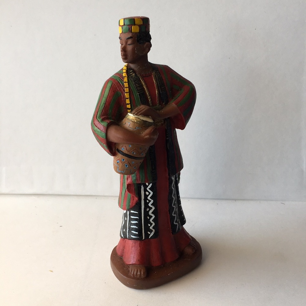 Man in African Tribal Wear Playing Drum Figurine